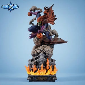 May include: A detailed statue of the Green Goblin from Spider-Man, featuring a green-skinned character in a purple and blue costume, holding pumpkin bombs. The statue is atop a building with flames and the words "Spider-Man" on the base.