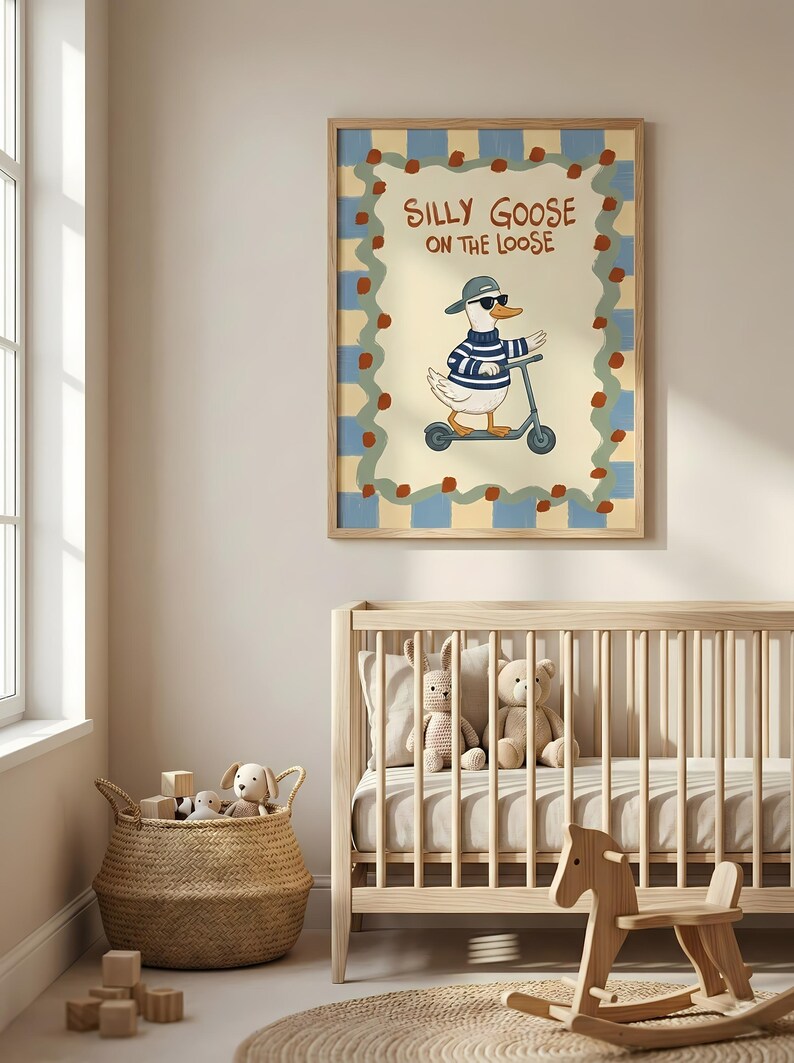 A nursery room with a crib, a rocking horse, and a basket filled with toys. Above the crib is a framed poster of a cartoon goose riding a scooter, with the text "Silly Goose on the Loose" written on it.