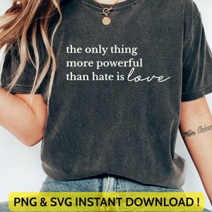 May include: Dark gray t-shirt with the text "the only thing more powerful than hate is love" in white script. The shirt also has the text "PNG & SVG INSTANT DOWNLOAD!" in a yellow banner at the bottom.