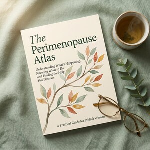 May include: A book titled "The Perimenopause Atlas" with text about understanding and finding help. The cover features a watercolor illustration of a branch with colorful leaves. A cup of tea and glasses are next to the book.