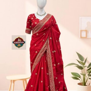 May include: A white ceramic mug with a black handle and the text "But First, Coffee" in a black, bold font. The mug is on a white surface.