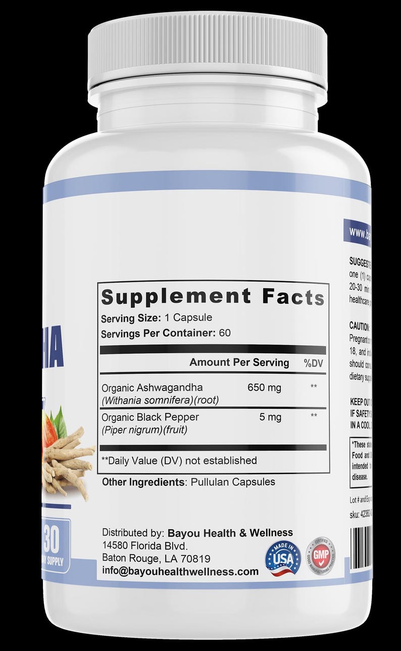 May include: A white supplement bottle with a blue stripe and a white cap. The label displays "Supplement Facts" with details on serving size and ingredients, including Organic Ashwagandha and Black Pepper. The bottle contains 60 capsules.