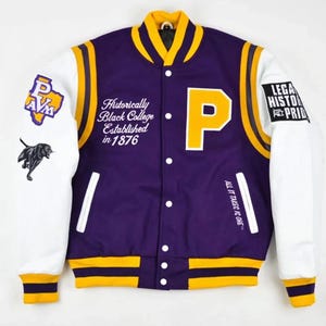 May include: Purple and white varsity jacket with yellow accents. Features a large yellow "P" on the front, text that reads "Historically Black College Established in 1876", and other patches. The sleeves are white.