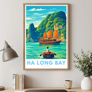 May include: A framed art print of Ha Long Bay, Vietnam. The artwork shows a traditional junk boat with orange sails on turquoise water, a small boat with a person, and green mountains under a blue sky. Text at the bottom reads "HA LONG BAY VIETNAM."