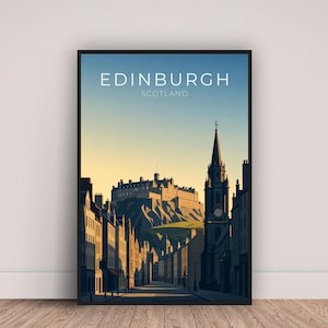 May include: A framed art print featuring a stylized illustration of Edinburgh, Scotland. The image shows a street scene with buildings, a castle on a hill, and the text "EDINBURGH SCOTLAND" at the top. The color palette includes shades of blue, yellow, and brown.