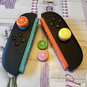 May include: A white ceramic mug with a black handle and the text "But First, Coffee" in a black, bold font. The mug is sitting on a white surface. The mug is approximately 4 inches tall.