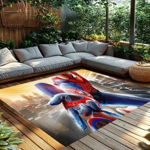 Pu&ograve; includere: Un tappeto rettangolare con un'immagine dinamica di Spider-Man. Il tappeto mostra il costume rosso e blu del personaggio su uno sfondo di paesaggio urbano. &Egrave; posizionato su un ponte di legno, vicino a un divano grigio e una vegetazione lussureggiante.