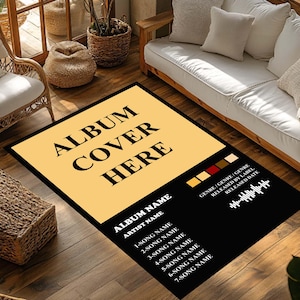 May include: A rectangular rug with a black border and a large yellow rectangle in the center. The text "ALBUM COVER HERE" is printed in black. Below, a black section lists album details, including song names and artist information.
