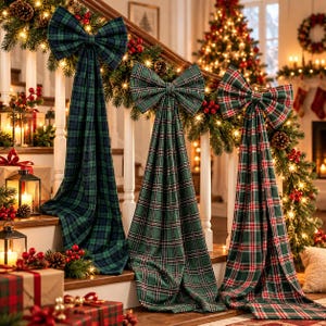 May include: Three large fabric bows with long, flowing tails draped over a staircase railing. The bows feature different plaid patterns in shades of green, navy blue, and red, accented by a decorated garland with lights and pinecones.
