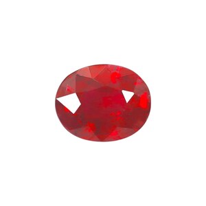 May include: A faceted, oval-shaped, deep red gemstone. The gem has a polished surface with multiple facets that reflect light. The color is a rich, saturated red, with some lighter areas. The gemstone is set against a white background.
