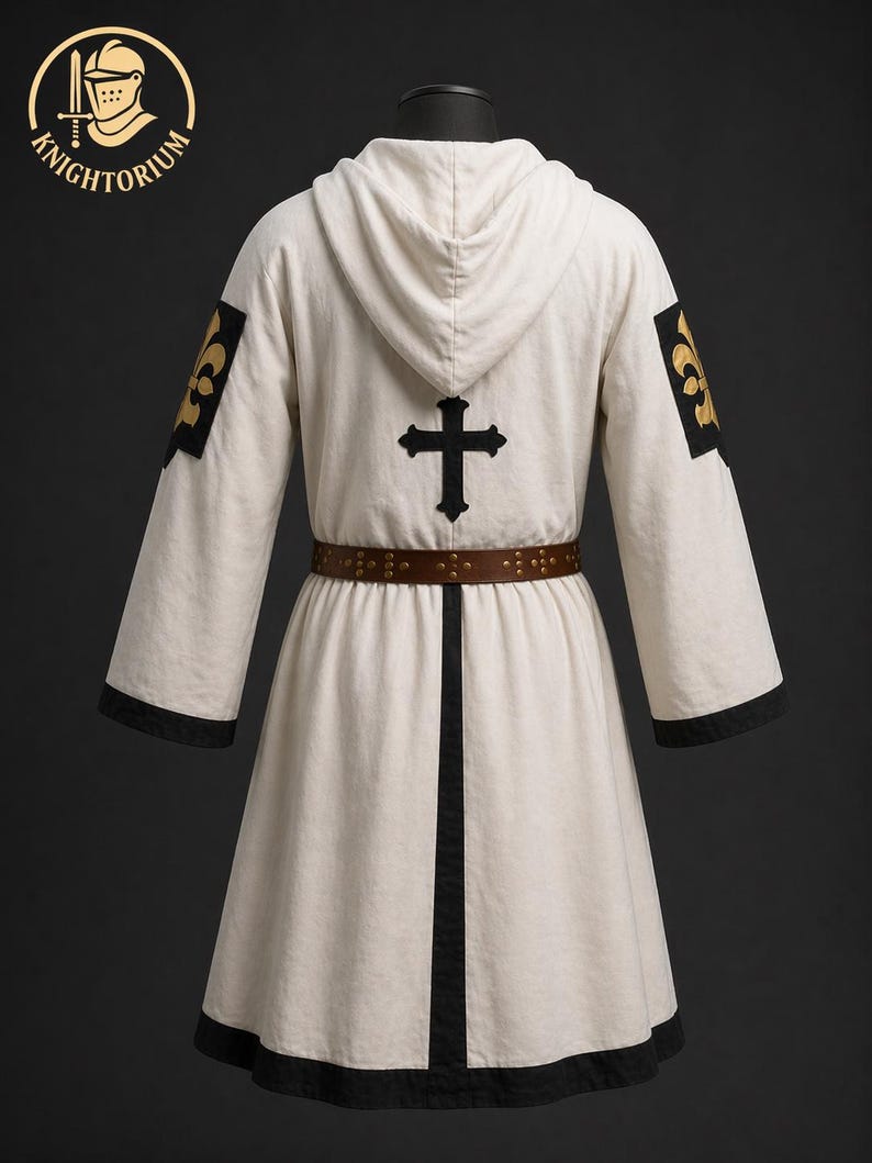 May include: Cream-colored hooded robe with black trim and a brown belt. The back features a black cross and gold fleur-de-lis patches on the sleeves. The robe is from Knightorium.