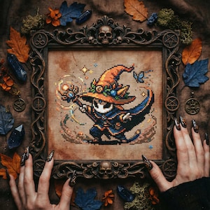 May include: Cross-stitch art of a wizard in an orange hat and blue cloak, framed in a dark wood frame with skull and pentagram details. The artwork is surrounded by autumn leaves, crystals, and moss.