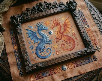 May include: Cross-stitch artwork depicting two dragons, one blue and one orange, facing each other with a yin-yang symbol between them. The artwork is framed in a dark, ornate wooden frame with carved details and runes. The background is a tan fabric.