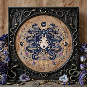 This celestial Medusa cross stitch pattern features a mystical serpent goddess surrounded by flowing cosmic snakes, golden moon symbols, celestial ornaments, and delicate floral accents. Inspired by mythology and dark fantasy aesthetics, the design transforms Medusa into a peaceful moonlit queen filled with elegance and magical energy. Deep navy blue tones blend with soft lavender, dusty pink, and gold celestial details to create an enchanting embroidery composition perfect for gothic home décor