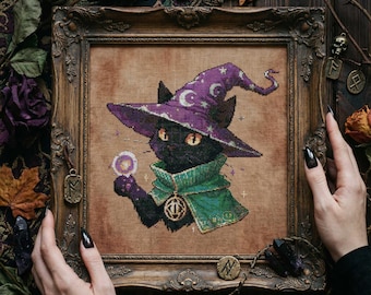 May include: Cross-stitch of a black cat in a purple wizard hat with moons and stars, and a green cape, holding a crystal ball. The artwork is framed in an ornate wooden frame. The cat has orange eyes.