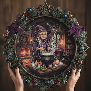 May include: A framed cross-stitch artwork depicting a witch stirring a cauldron in a cozy room. The artwork is surrounded by a decorative wreath with green foliage, berries, and ornaments. The witch wears a purple hat and robe. The frame is bronze-colored.