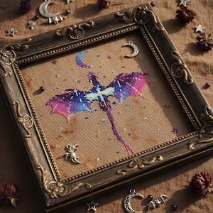 May include: Cross-stitch art of a dragon with a celestial theme, in a decorative, ornate, dark brown frame. The dragon has a gradient of purple, blue, and pink hues. The background is a tan fabric.