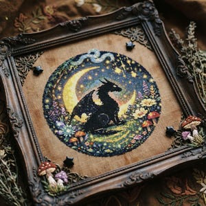 May include: Cross-stitch artwork featuring a black dragon on a crescent moon, set against a starry night sky. The piece is framed in a dark, ornate wooden frame, with decorative mushrooms and stars. The scene is filled with colorful flowers and foliage.