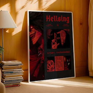 May include: A framed poster with the title "Hellsing" in red lettering. The artwork features a red and black color scheme with a manga-style illustration of a character with a sinister grin and red eyes. The poster is leaning against a wooden wall.