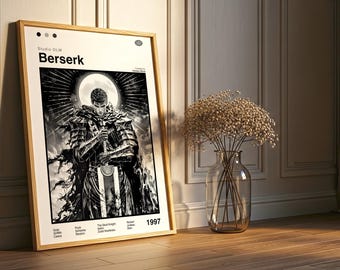 May include: A framed black and white poster featuring the word "Berserk" at the top. The artwork depicts a warrior holding a sword, set against a moonlit background. The poster is in a wooden frame and leans against a wall.