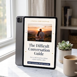 May include: A tablet displaying a digital guide titled The Difficult Conversation Guide: A Practical Guide for Couples. The screen shows a photograph of a couple embracing at sunset, with the subtitle How to talk about hard things without starting a fight.