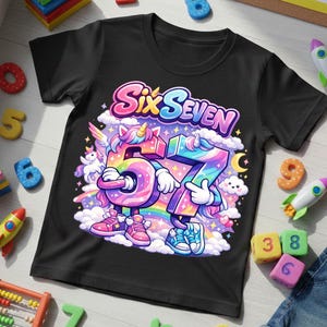 May include: Black t-shirt with a colorful graphic featuring the words "Six Seven" above the numbers 6 and 7, designed as cartoon characters with unicorn horns, rainbows, and clouds. The shirt is surrounded by colorful toy numbers and rockets.