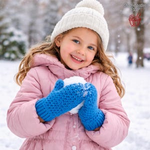 May include: A young person wearing a white knit hat and blue mittens, holding a snowball. The person is wearing a pink jacket and smiling. The image is set in a snowy outdoor environment. Text in the upper right corner reads "Crochet pattern PDF".