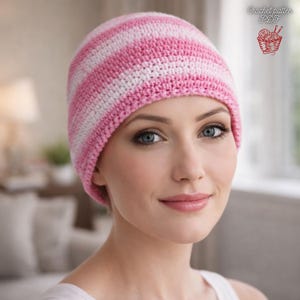 May include: A pink and white striped crochet beanie. The hat is made of soft yarn and has a classic striped pattern. The beanie is a comfortable and stylish accessory for cooler weather. The image also includes the text "Crochet pattern PDF".
