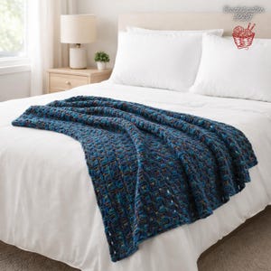 May include: A blue and teal crocheted blanket draped over a white bed. The blanket has a textured pattern and is made of yarn with flecks of brown and other colors. The text "Crochet pattern PDF" is in the upper right corner.