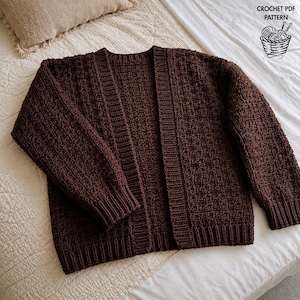 May include: A dark brown crochet cardigan featuring a textured stitch pattern, long sleeves, and ribbed cuffs and hem. The front is open with a vertical ribbed placket. The text CROCHET PDF PATTERN is visible in the top right corner.