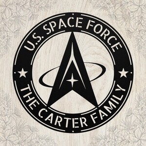 May include: Black metal sign featuring the U.S. Space Force logo, a stylized 'A' shape with a star and orbiting lines, encircled by text. The text reads 'U.S. SPACE FORCE' and 'THE CARTER FAMILY'. Two stars flank the logo.