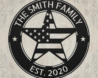 May include: A circular black metal wall sign featuring a central star with a flag pattern. The text THE SMITH FAMILY is arched across the top, and EST. 2020 is at the bottom. Two small stars are positioned on the left and right sides of the circle.