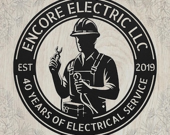 May include: A circular black metal sign featuring a silhouette of an electrician wearing a hard hat and holding tools. The text reads ENCORE ELECTRIC LLC, EST 2019, and 40 YEARS OF ELECTRICAL SERVICE arranged within the circular border design.