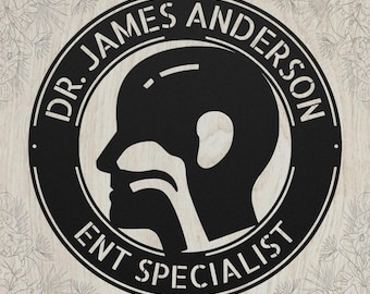 May include: A circular black metal sign featuring a silhouette of a human head in profile with the internal anatomy of the ear, nose, and throat visible. The text DR. JAMES ANDERSON is at the top and ENT SPECIALIST is at the bottom of the border.