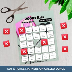 May include: A 2000s Hits Music Bingo game card with red X markers, a pink MP3 player, and scissors. The card features song titles and artist names. Text on the card reads "Cut & Place Markers on Called Songs" and "EverPlayAtelier.etsy.com."