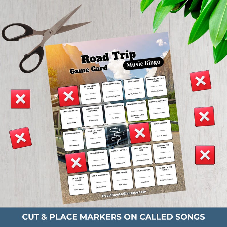 May include: A Road Trip Music Bingo game card with song titles, red markers, and scissors. The card features a mountain landscape background and the text "Cut & Place Markers on Called Songs."