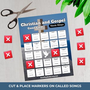 May include: A Christian and Gospel Music Bingo game card with a cross graphic. The card features song titles and spaces for markers, with red X markers scattered around. A pair of scissors is also present.