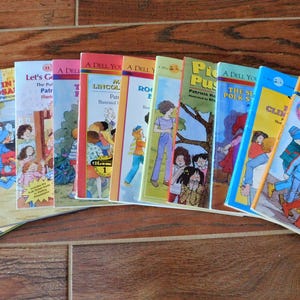 May include: A collection of 12 colorful paperback children's books with various titles, including "The Secret Polka Dot", "Let's Go To The Fair", "A Lincoln Doll", "Dinosaurs", "Peace, Secret", "Pick A Puzzle", "Cleopatra", "Best Friends", and "Robert's Day".