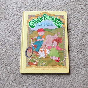 May include: A vintage "Cabbage Patch Kids" storybook titled "Making Friends." The cover features illustrations of children, a dog, and a bicycle. The book is a Parker Brothers Story Book.