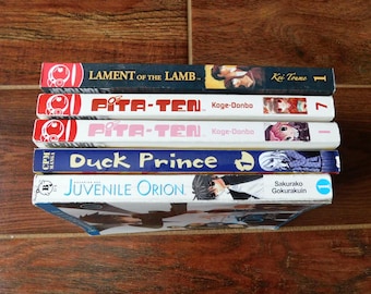 May include: A stack of five manga graphic novels with colorful covers. The titles include "Lament of the Lamb", "Pita-Ten", "Duck Prince", and "Juvenile Orion".