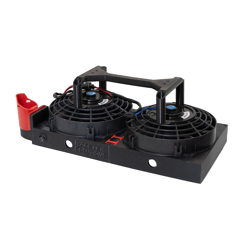 May include: Black dual electric fan assembly with a red mounting bracket. The assembly includes two black fans, a black base, and a black support structure. The text "RACETEK SOLUTIONS II" is visible on the base.