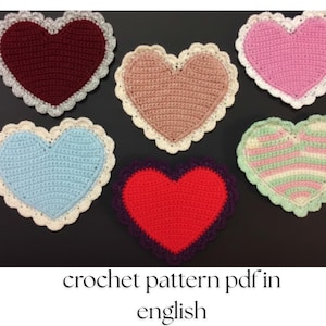 May include: A collection of six handmade crochet heart-shaped items in various colors, including red, pink, blue, and green, each with a white scalloped border. The text "crochet pattern pdf in english" is at the bottom.