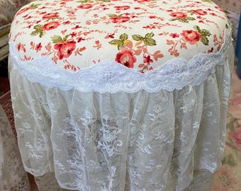 A shabby vanity chair, bathroom chair, floral pattern fabric with roses and flowing lace