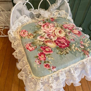 A shabby vanity chair, bathroom chair, floral pattern fabric with roses and flowing lace