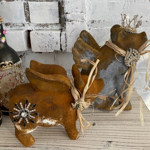 A pair of aged flying crown pigs, rusty set, shelf sitters