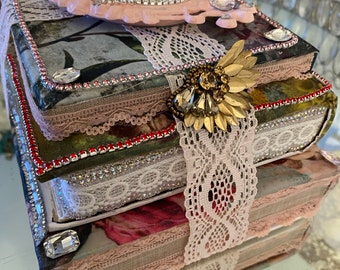 A bohemian style bookstack, with jewels, table decor, books