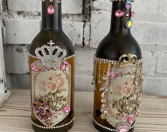 A pair of embellished bottle, candleholders, votive