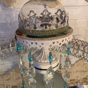 An eclectic style raised tray with a glass dome/Cloche, rhinestones