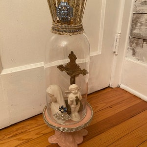 An eclectic style raised tray with a feathered metal crown glass dome/Cloche, rhinestones