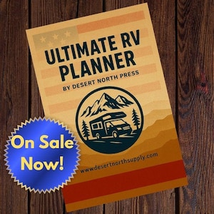 May include: A planner titled "Ultimate RV Planner" with a logo of a camper van in front of mountains and trees. The planner has a beige and orange color scheme with the text "On Sale Now!" on a blue sticker.